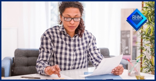 Lady looking at papers at table