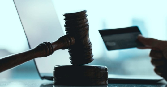 Gavel and credit card silhouette