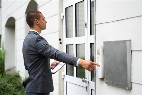 Bailiff Debt Collector Touching Doorbell.